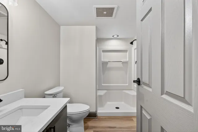 a white toilet sitting next to a bathroom sink