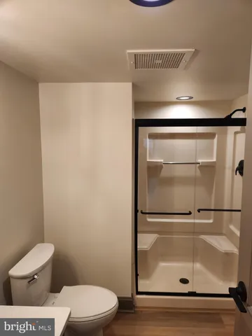 a bathroom with a toilet and a shower