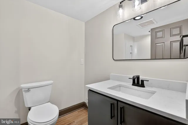a bathroom with a toilet sink and mirror