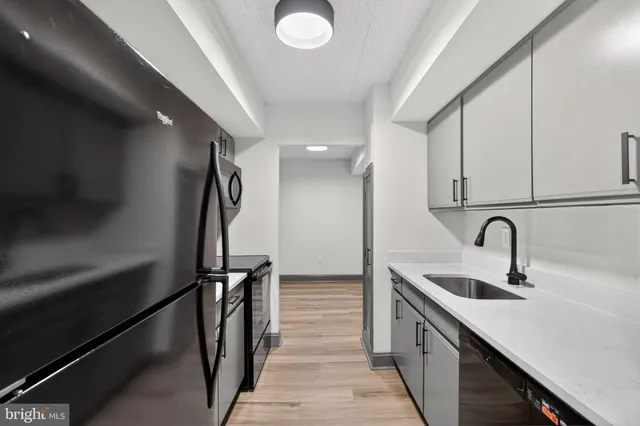 a kitchen with a sink and a refrigerator