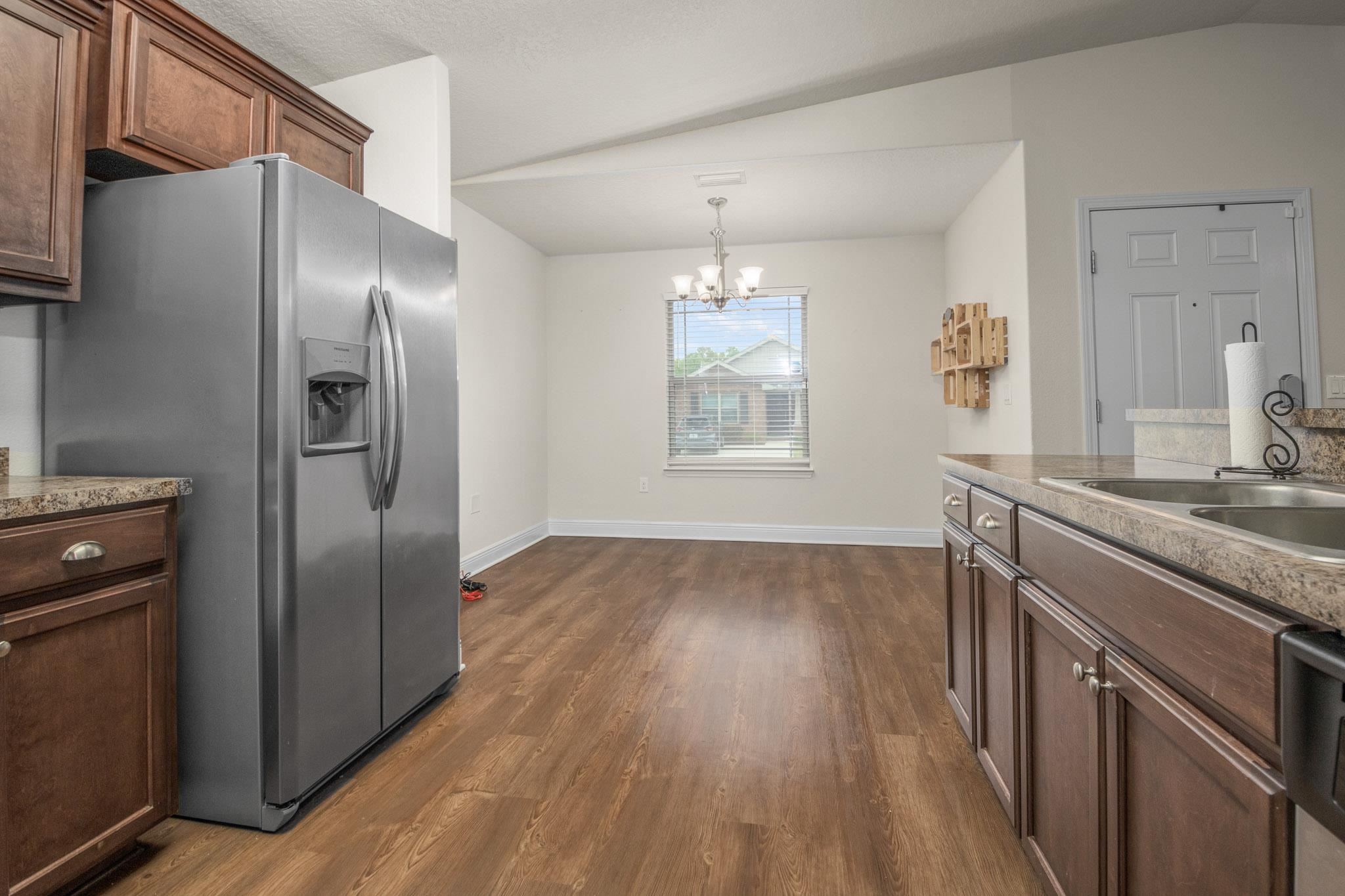 5070 Carmell Ridge Circle Milton, FL 32570 - Photo 12 of 36 a kitchen with stainless steel appliances granite countertop a refrigerator and a sink