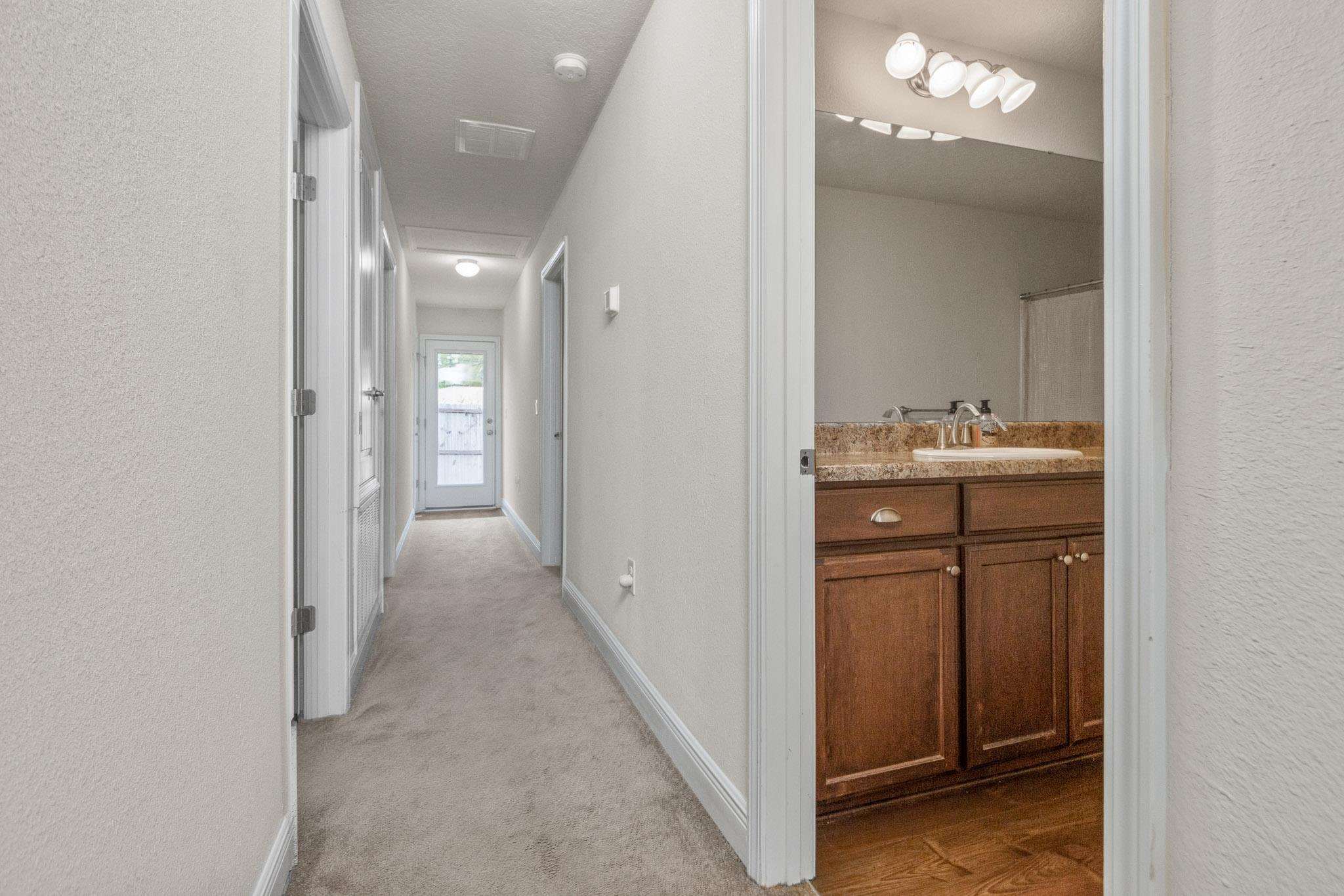5070 Carmell Ridge Circle Milton, FL 32570 - Photo 15 of 36 a view of a hallway to a room with dining table and chairs