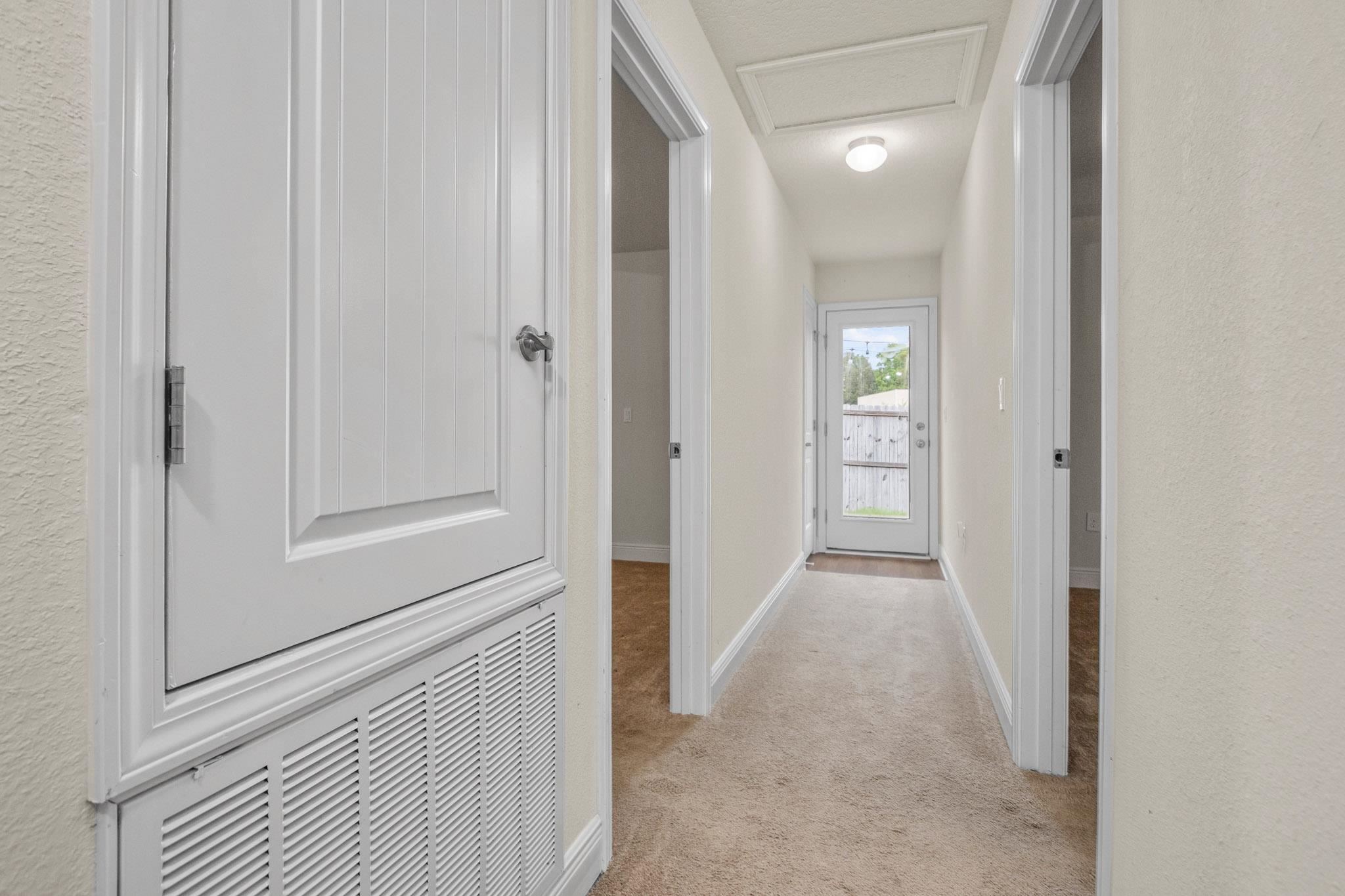 5070 Carmell Ridge Circle Milton, FL 32570 - Photo 21 of 36 a view of a hallway with a wooden door