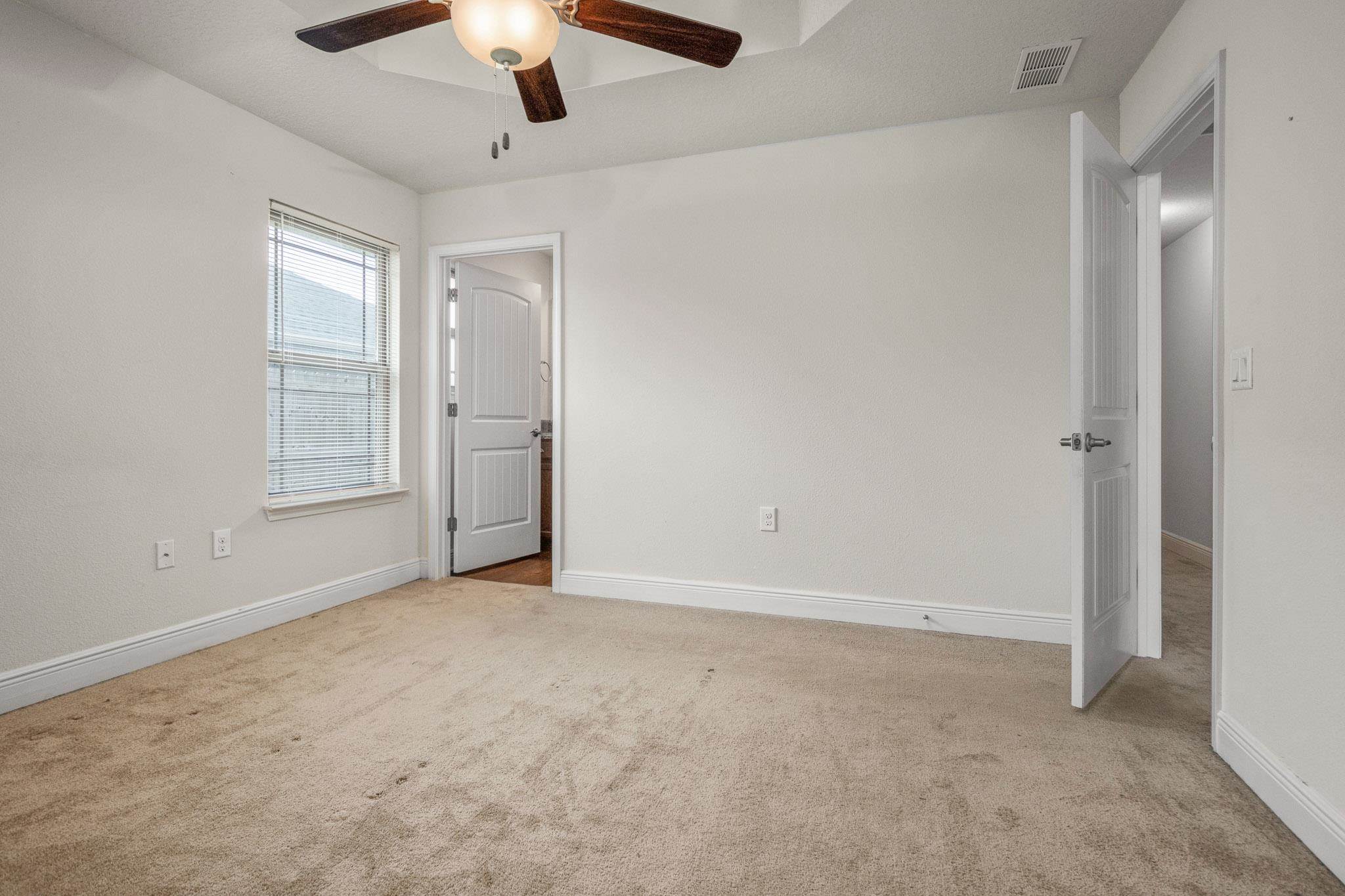 5070 Carmell Ridge Circle Milton, FL 32570 - Photo 26 of 36 an empty room with chandelier fan and windows