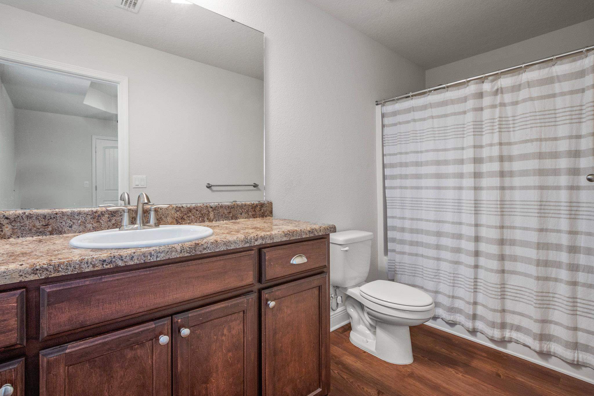 5070 Carmell Ridge Circle Milton, FL 32570 - Photo 28 of 36 a bathroom with a granite countertop sink toilet and shower
