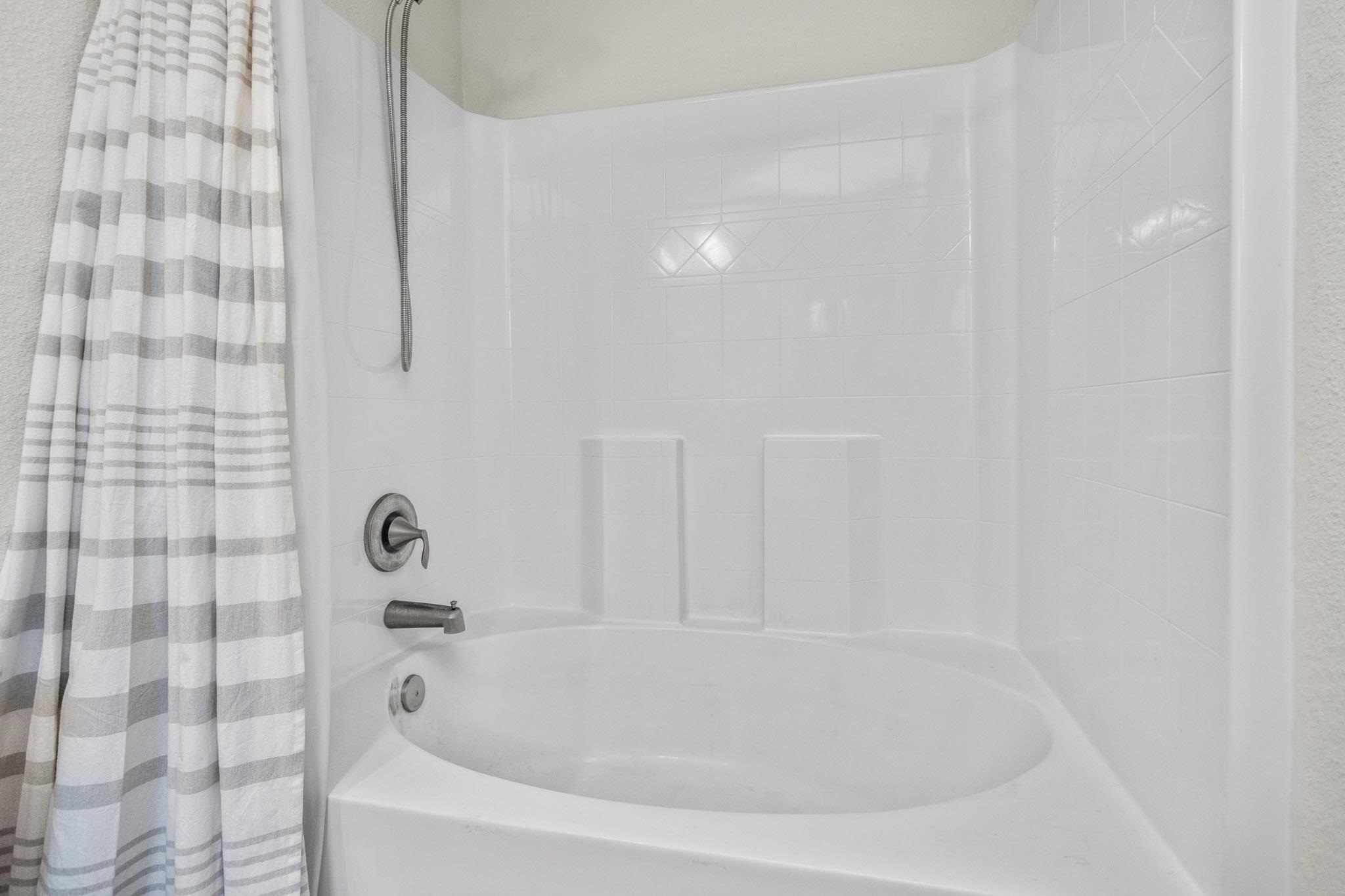 5070 Carmell Ridge Circle Milton, FL 32570 - Photo 30 of 36 a white bath tub sitting in a bathroom