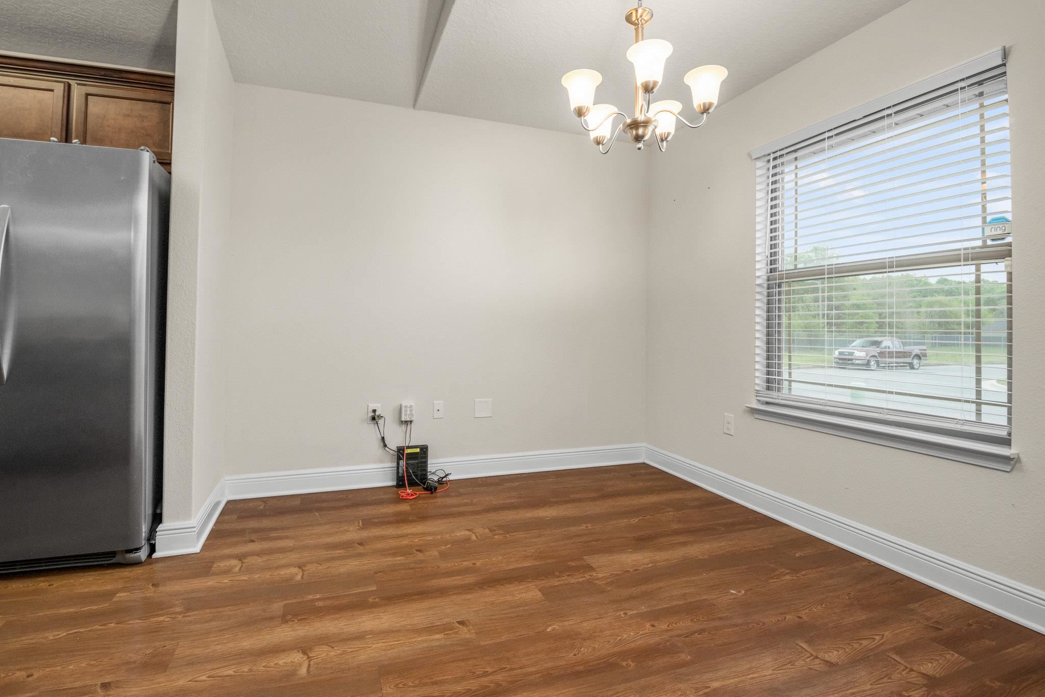 5070 Carmell Ridge Circle Milton, FL 32570 - Photo 7 of 36 a view of a room with a chandelier fan and a window