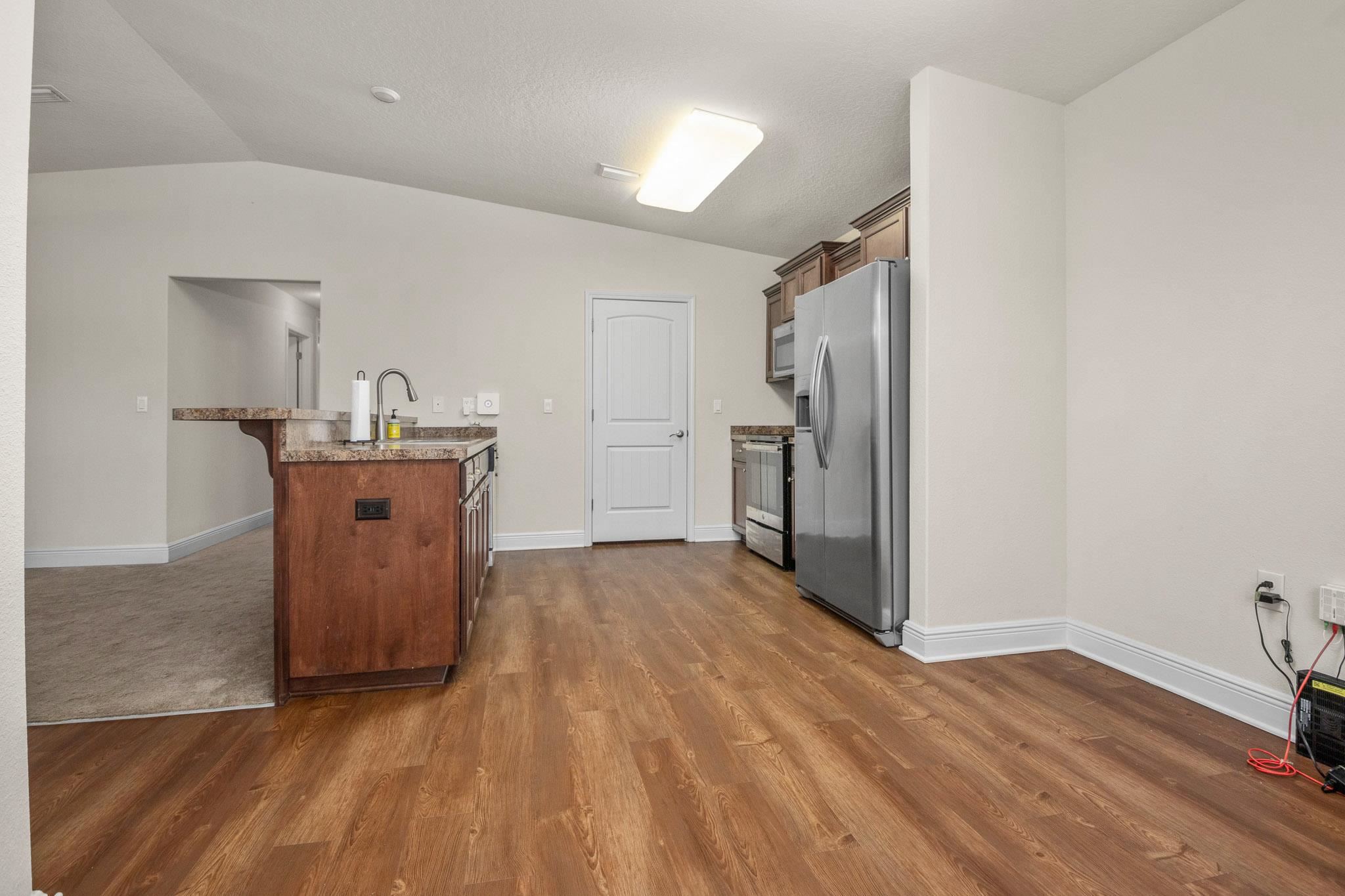5070 Carmell Ridge Circle Milton, FL 32570 - Photo 8 of 36 a kitchen with granite countertop a refrigerator and a stove top oven