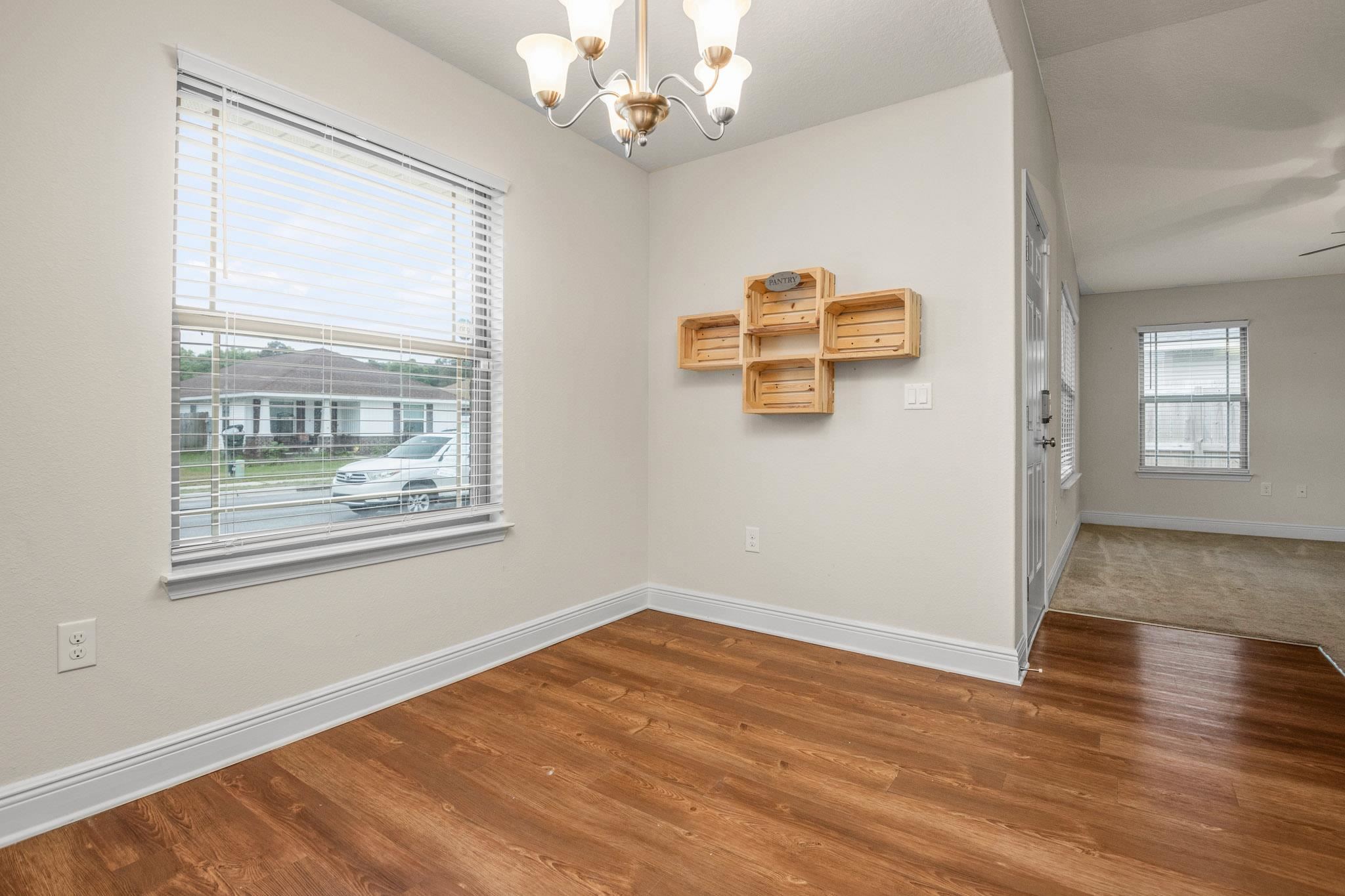 5070 Carmell Ridge Circle Milton, FL 32570 - Photo 9 of 36 a view of an empty room with a window and wooden floor