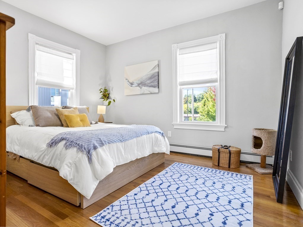 8 Marbury Terrace, Unit 1 Boston, MA 02130 - Photo 11 of 35 a bedroom with a bed and wooden floor