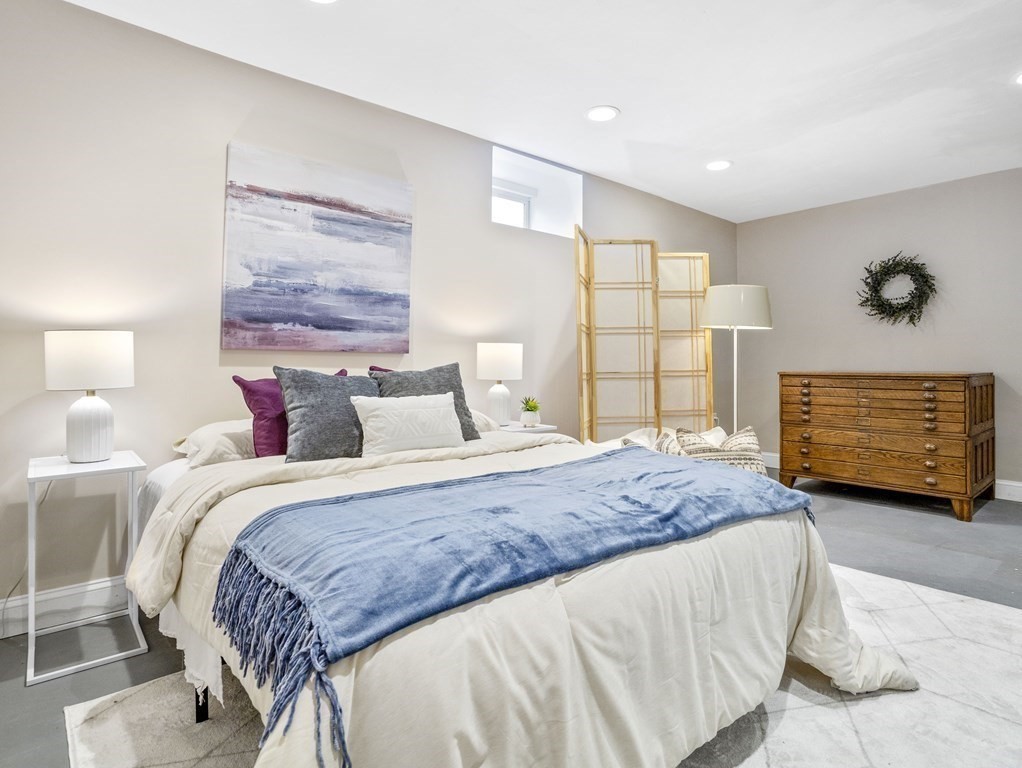 8 Marbury Terrace, Unit 1 Boston, MA 02130 - Photo 14 of 35 a spacious bedroom with a bed a couch and a window