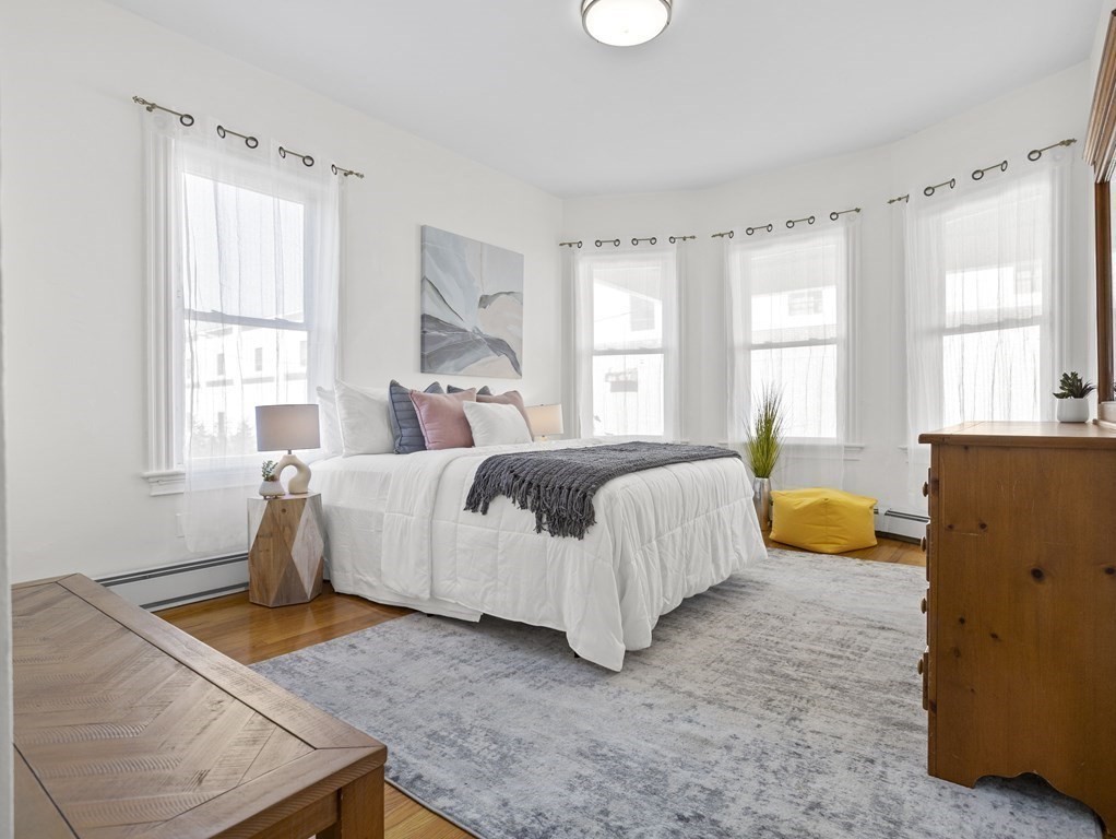 8 Marbury Terrace, Unit 1 Boston, MA 02130 - Photo 8 of 35 a bedroom with a bed and wooden floor