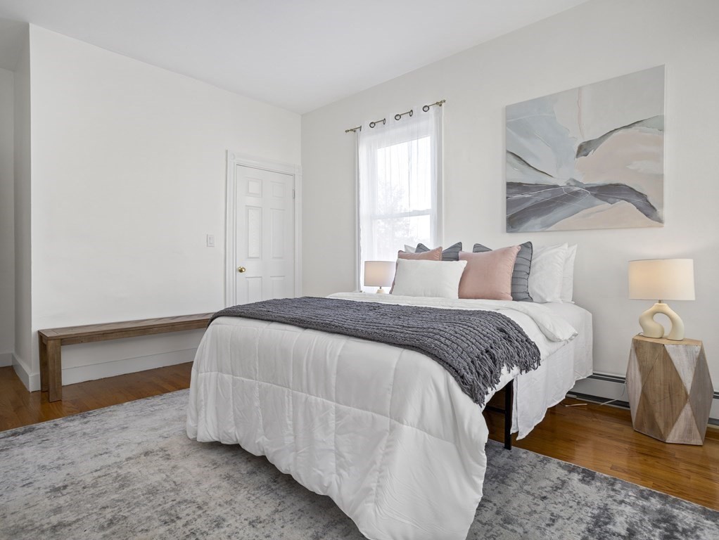 8 Marbury Terrace, Unit 1 Boston, MA 02130 - Photo 9 of 35 a bedroom with a bed and wooden floor