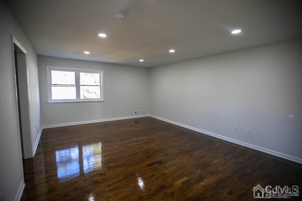 3301 Hana Road Edison, NJ 08817 - Photo 34 of 39 an empty room with wooden floor and windows