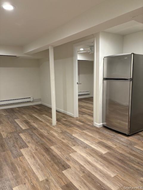 28 West Neck Road, Unit 14 Huntington, NY 11743 - Photo 7 of 13 Finished below grade area featuring freestanding refrigerator, recessed lighting, light wood-type flooring, and a baseboard heating unit