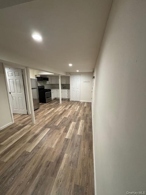 28 West Neck Road, Unit 14 Huntington, NY 11743 - Photo 10 of 13 Finished basement featuring light wood finished floors, freestanding refrigerator, and recessed lighting