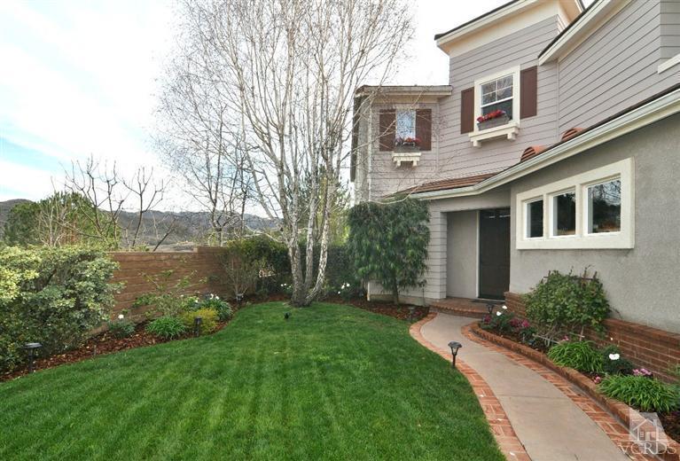 394 Woodland Road Simi Valley, CA 93065 - Photo 3 of 26 a front view of a house with garden