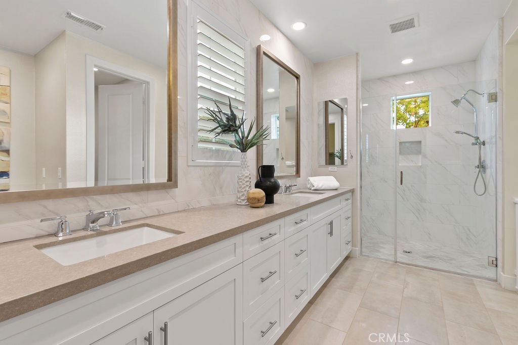 8 Platal Street Rancho Mission Viejo, CA 92694 - Photo 15 of 40 a bathroom with a granite countertop sink and a mirror