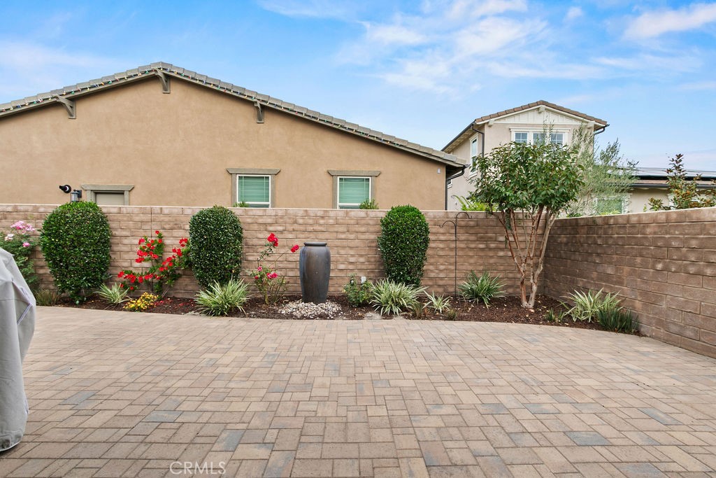8 Platal Street Rancho Mission Viejo, CA 92694 - Photo 22 of 40 a front view of a house with a yard and potted plants