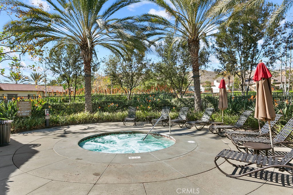 8 Platal Street Rancho Mission Viejo, CA 92694 - Photo 34 of 40 a view of a swimming pool with a patio and a garden