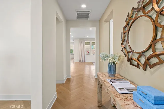 a view of a bedroom with furniture mirror and fan
