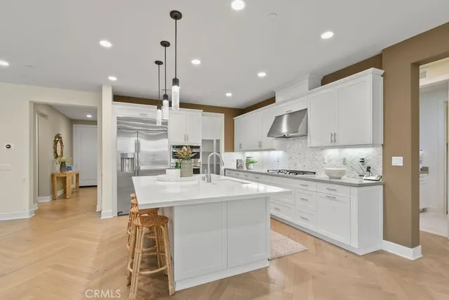 a kitchen with kitchen island a sink stainless steel appliances and cabinets