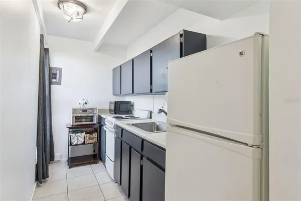 a kitchen with a sink and a refrigerator