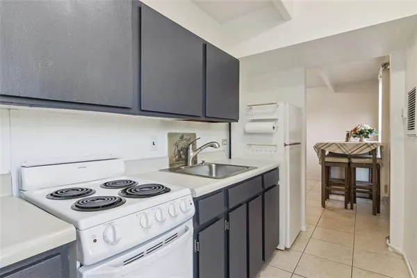 a kitchen with a stove and a refrigerator