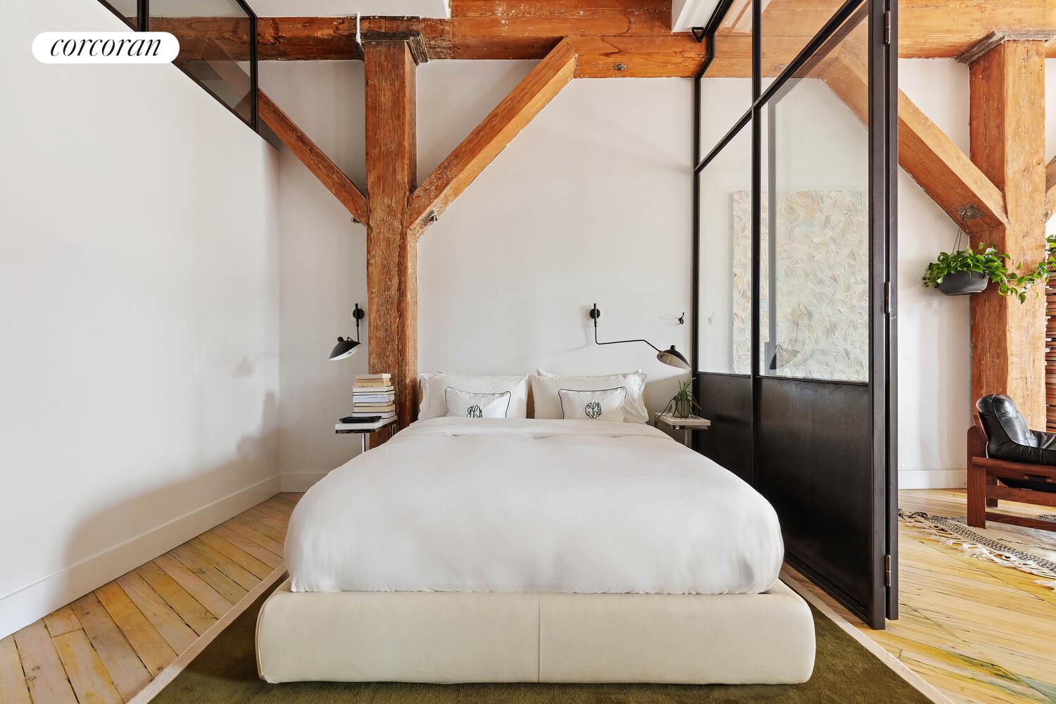 85 North 3rd Street, Unit 309 Brooklyn, NY 11249 - Photo 9 of 16 a bedroom with a bed and a night stand