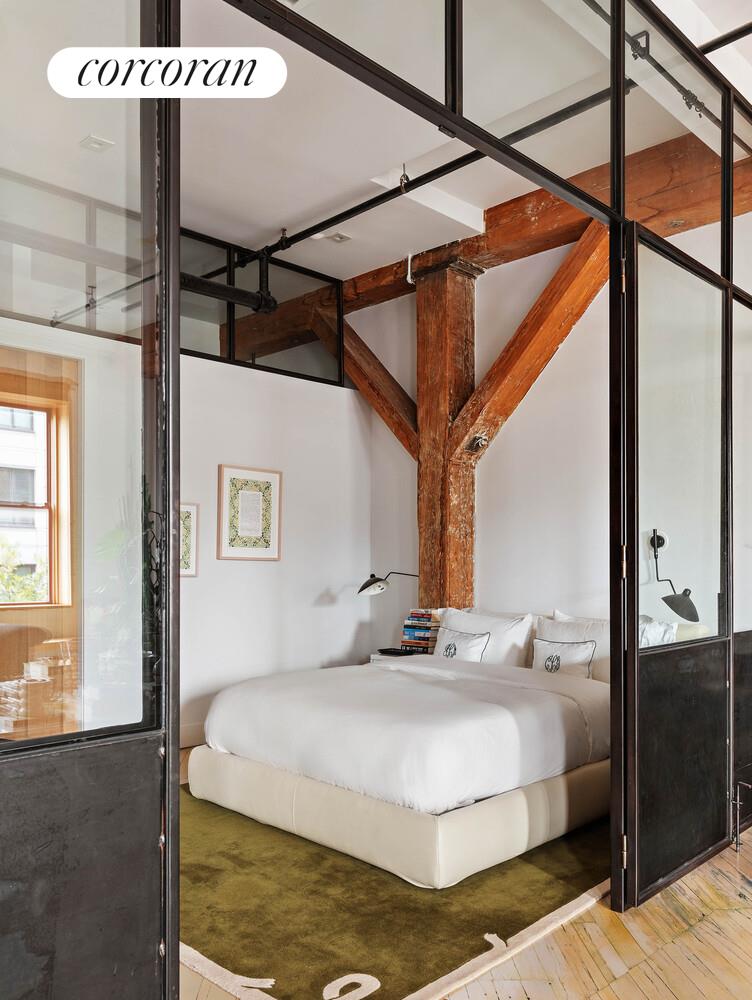 85 North 3rd Street, Unit 309 Brooklyn, NY 11249 - Photo 10 of 16 a bedroom with a bed and wooden floor