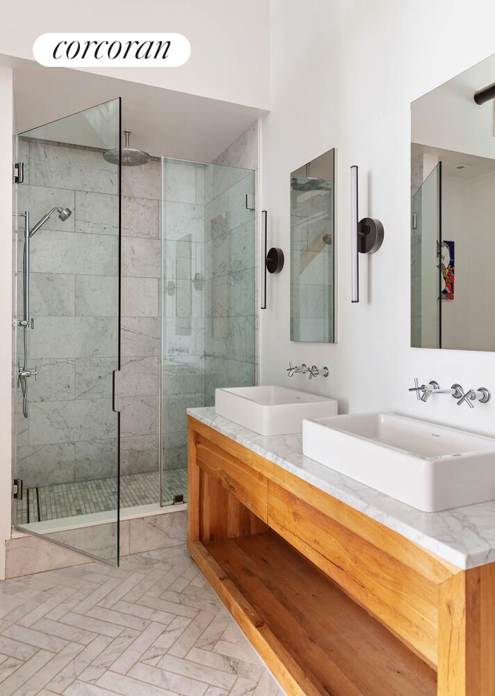 85 North 3rd Street, Unit 309 Brooklyn, NY 11249 - Photo 12 of 16 a bathroom with a tub sink and mirror