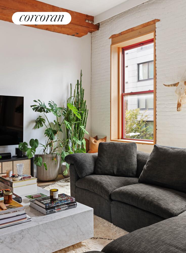 85 North 3rd Street, Unit 309 Brooklyn, NY 11249 - Photo 2 of 16 a living room with furniture and a potted plant