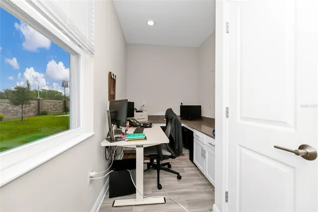 a kitchen with stainless steel appliances granite countertop a refrigerator a stove a sink a island a dining table and chairs