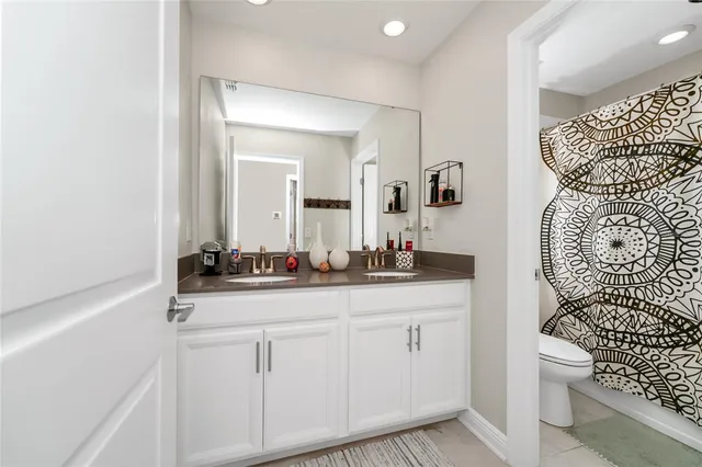 a bedroom with furniture and a flat screen tv