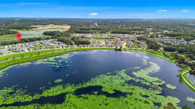 a view of a white house with a big yard