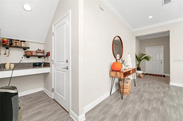 a view of a room with wooden floor and furniture