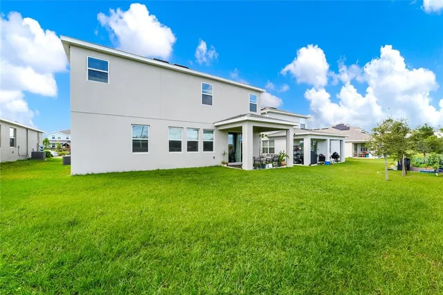 an aerial view of a house with a garden and lake view