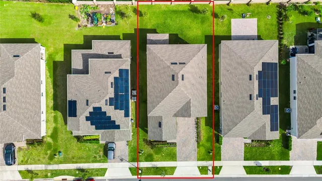 an aerial view of a house with a yard basket ball court and outdoor seating