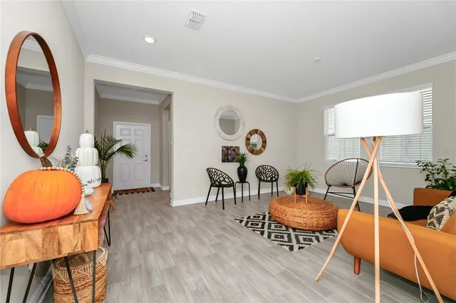 a living room with furniture and a wooden floor
