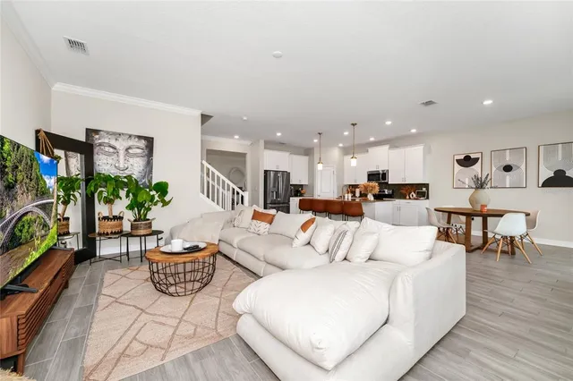 a living room with furniture kitchen view and a table