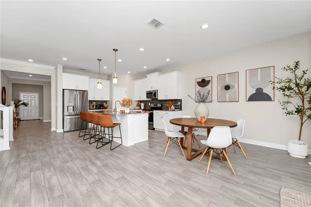 a living room with furniture and kitchen view