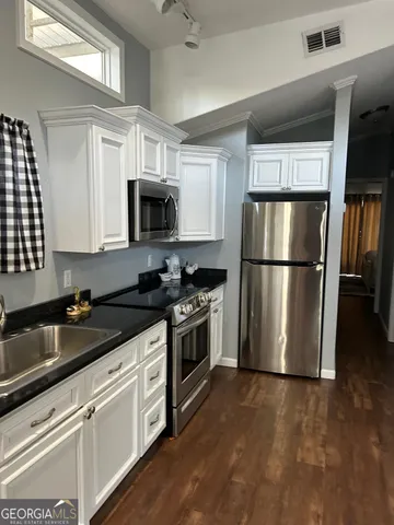 a kitchen with a refrigerator stove and microwave