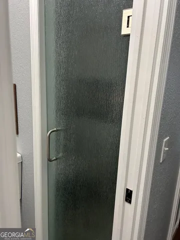 a bathroom with a glass shower door