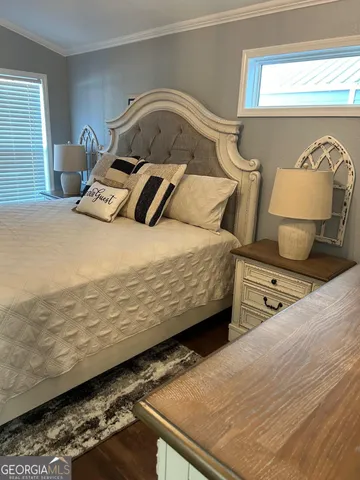 a bedroom with a bed and lamp