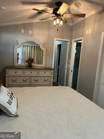 a view of bedroom with a flat tv screen on dresser