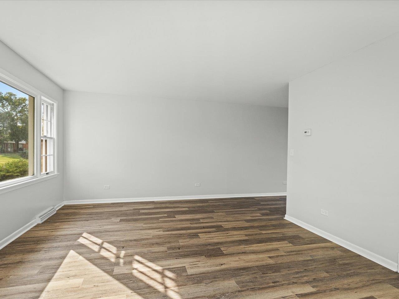 334 Northway Park Road Machesney Park, IL 61115 - Photo 11 of 28 a view of an empty room with wooden floor and a window