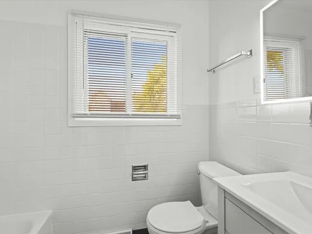 a white toilet sitting next to a bathroom sink