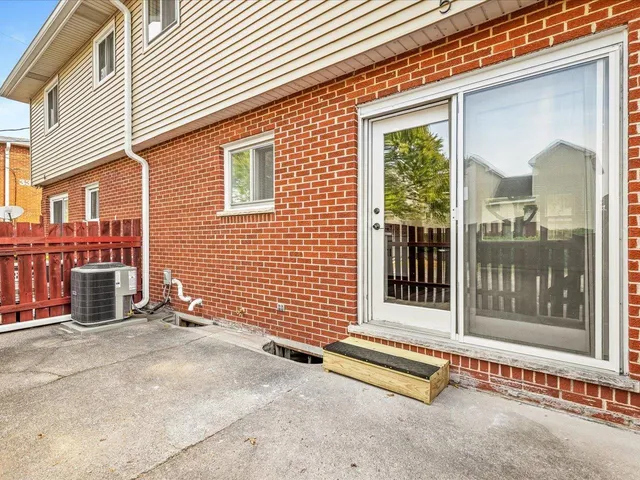 a view of a brick house with a large window