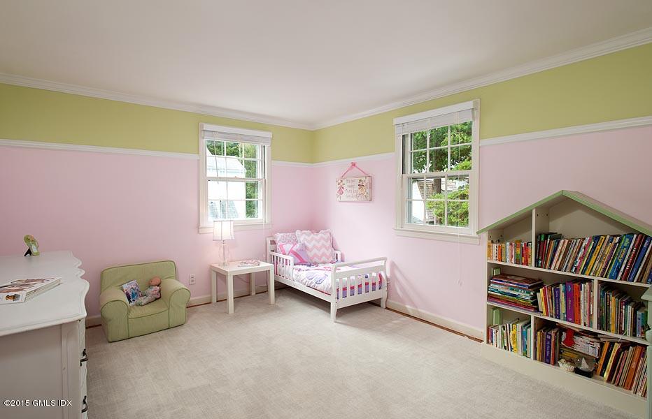 24 Meadow Road Riverside, CT 06878 - Photo 12 of 16 a bedroom with a bed and a book shelf