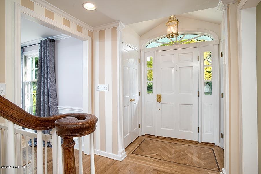 24 Meadow Road Riverside, CT 06878 - Photo 2 of 16 a view of a hallway with a chandelier and livingroom view